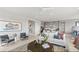 Bright living room with a modern kitchen, stylish furniture, and contemporary artwork creating a cozy ambiance at 344 Tigullio Ave, Henderson, NV 89011