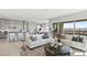 Open-concept living room with a view of the kitchen, dining area, and large sliding doors to outdoor space at 344 Tigullio Ave, Henderson, NV 89011