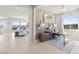 Bright and modern study featuring ample natural light, a stylish desk, and elegant decorative mirrors at 344 Tigullio Ave, Henderson, NV 89011
