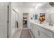 Well-lit bathroom with a double sink vanity, a glass-enclosed shower, and access to a walk-in closet at 3782 Neblina Dr, Henderson, NV 89052