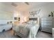 Bright bedroom featuring a queen-size bed, decorative wall art, and a matching dresser and nightstand at 3782 Neblina Dr, Henderson, NV 89052