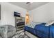 Comfortable bedroom showcasing a mirrored dresser, accent chair, and access to a bathroom at 3782 Neblina Dr, Henderson, NV 89052