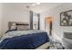 Comfortable bedroom with an upholstered headboard, cozy bedding, and a view into the walk-in closet at 3782 Neblina Dr, Henderson, NV 89052