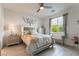 Cozy bedroom showcasing a comfortable bed, a ceiling fan, and lots of natural light from the window at 3782 Neblina Dr, Henderson, NV 89052