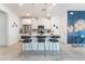 Modern kitchen with white cabinetry, stainless steel appliances, and a breakfast bar with seating at 3782 Neblina Dr, Henderson, NV 89052