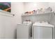 Convenient laundry room featuring a newer model washer and dryer and shelf for storage at 3782 Neblina Dr, Henderson, NV 89052