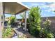 Landscaped patio area with covered seating and decorative plants, perfect for outdoor relaxation at 3782 Neblina Dr, Henderson, NV 89052
