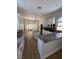 Bright kitchen featuring white cabinets, granite countertops, stainless steel appliances, and wood flooring at 379 Marlin Cove Rd, Henderson, NV 89012