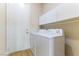This is a laundry room with a washer and dryer and white cabinets for storage at 379 Marlin Cove Rd, Henderson, NV 89012