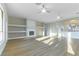 Bright living room with fireplace, built-ins, ceiling fan, and wood-look floors at 379 Marlin Cove Rd, Henderson, NV 89012