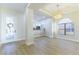 Open-concept living room featuring wood floors, modern lighting, and seamless flow into the adjacent kitchen at 379 Marlin Cove Rd, Henderson, NV 89012