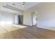 Large main bedroom with tray ceiling, ceiling fan, and light wood-look flooring at 379 Marlin Cove Rd, Henderson, NV 89012