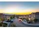 Picturesque street view with well-maintained homes, landscaping, and a glimpse of the city skyline in the distance at 379 Marlin Cove Rd, Henderson, NV 89012