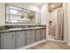 Bright bathroom features a double sink vanity with shower and wood-look floors at 3930 Maranatha Cir, Las Vegas, NV 89103