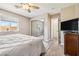 Well-lit bedroom with large window, plush carpet and a mirrored closet door at 3930 Maranatha Cir, Las Vegas, NV 89103