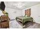 The bedroom has unique decor, wood flooring and a ceiling fan at 3930 Maranatha Cir, Las Vegas, NV 89103