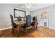Formal dining room features wood floors, elegant chairs and a large mirror at 3930 Maranatha Cir, Las Vegas, NV 89103