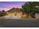 Charming single-Gathering home featuring a brick exterior, lush landscaping, and a two-car garage at 3930 Maranatha Cir, Las Vegas, NV 89103