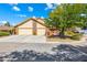 Charming single-Gathering home featuring a 2-car garage, a red door and a nicely landscaped front yard at 3930 Maranatha Cir, Las Vegas, NV 89103
