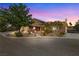 Charming single-Gathering home featuring a brick exterior, lush landscaping, and a two-car garage at 3930 Maranatha Cir, Las Vegas, NV 89103