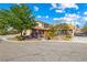 Charming single-Gathering home featuring a circular driveway, mature landscaping, and a vibrant red front door at 3930 Maranatha Cir, Las Vegas, NV 89103