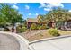 Beautiful front yard with well-maintained landscaping, including mature trees, shrubs, and decorative rock features at 3930 Maranatha Cir, Las Vegas, NV 89103