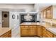 Open kitchen with granite countertops, a kitchen island, and a view into the dining room at 3930 Maranatha Cir, Las Vegas, NV 89103