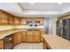 Well-lit kitchen with granite counters, modern appliances, and a central island cooktop at 3930 Maranatha Cir, Las Vegas, NV 89103
