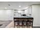 The kitchen features sleek white cabinetry, a countertop bar, and is well-equipped with modern appliances at 3930 Maranatha Cir, Las Vegas, NV 89103