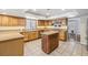 Bright kitchen featuring tile floors, granite countertops, and a convenient kitchen island at 3930 Maranatha Cir, Las Vegas, NV 89103
