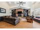 Inviting living room with a brick fireplace and dark wood accents at 3930 Maranatha Cir, Las Vegas, NV 89103