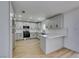 Bright, open kitchen with light gray cabinets, modern appliances, and breakfast bar at 3986 Belleville Ave, Las Vegas, NV 89121