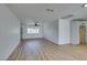 Spacious living room with new wood-look floors, ceiling fan, and a large window at 3986 Belleville Ave, Las Vegas, NV 89121