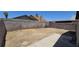 Large backyard featuring dirt and gravel surrounded by tall concrete walls for maximum privacy at 4041 Saguaro Ln, Las Vegas, NV 89110