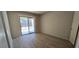 Bedroom with sliding glass doors to backyard, modern flooring, and neutral color at 4041 Saguaro Ln, Las Vegas, NV 89110