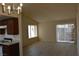 Open-concept living room and kitchen area, with a glass sliding door at 4041 Saguaro Ln, Las Vegas, NV 89110