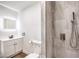 Stylish bathroom with an LED mirror, floating vanity, toilet, and a tiled walk-in shower with a handheld fixture at 408 Bolsa Dr, Las Vegas, NV 89110