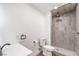 Contemporary bathroom featuring a walk-in shower with marble-look tiles, toilet, and a sleek vanity at 408 Bolsa Dr, Las Vegas, NV 89110