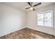 Bright bedroom with wood-look flooring, a window, and a ceiling fan, offering a simple and comfortable space at 408 Bolsa Dr, Las Vegas, NV 89110