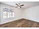 Clean bedroom featuring a large window with a backyard view, wood-look flooring, and a ceiling fan at 408 Bolsa Dr, Las Vegas, NV 89110