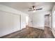 Minimalist bedroom with wood-look flooring, a ceiling fan, closet, and an en-suite bathroom access at 408 Bolsa Dr, Las Vegas, NV 89110