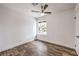 Bright bedroom with wood floors, ceiling fan, and natural light from the window at 408 Bolsa Dr, Las Vegas, NV 89110