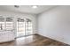 Bright dining area adjacent to the kitchen, featuring wood-look floors and a sliding glass door to the backyard at 408 Bolsa Dr, Las Vegas, NV 89110