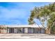 Charming single-story home with a freshly painted exterior, large tree, and well-manicured landscaping at 408 Bolsa Dr, Las Vegas, NV 89110