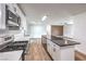 Bright kitchen showcasing white cabinets, a stainless steel range, and an island with seating and storage at 408 Bolsa Dr, Las Vegas, NV 89110