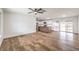 Spacious open-concept living space with wood-look floors and a view of the modern kitchen at 408 Bolsa Dr, Las Vegas, NV 89110
