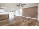 Open living space with wood-look floors, a wood accent wall, and seamless transition to the kitchen at 408 Bolsa Dr, Las Vegas, NV 89110