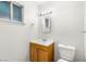 Bathroom featuring a sink with cabinet, toilet, window, and updated fixtures at 4201 Sunrise Ave, Las Vegas, NV 89110