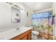 Bathroom featuring a single sink vanity, toilet, and decorative shower curtain at 4201 Sunrise Ave, Las Vegas, NV 89110