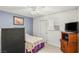 Bedroom with a bed, TV, and mini-fridge, offering comfort and convenience at 4201 Sunrise Ave, Las Vegas, NV 89110